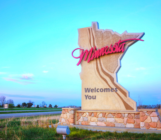 Minnesota welcome sign with the highway in the background