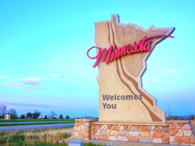 Minnesota welcome sign with the highway in the background